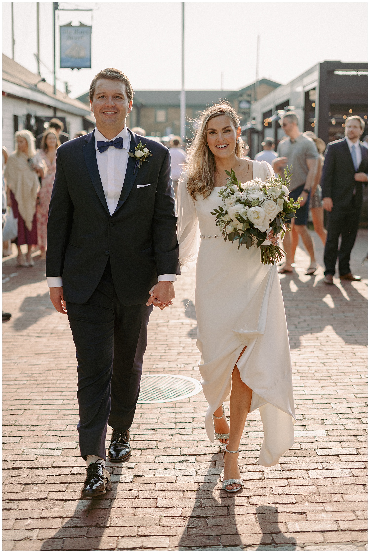 Bride and Groom walking through crowd on Bowens Wharf in Newport Rhode Island