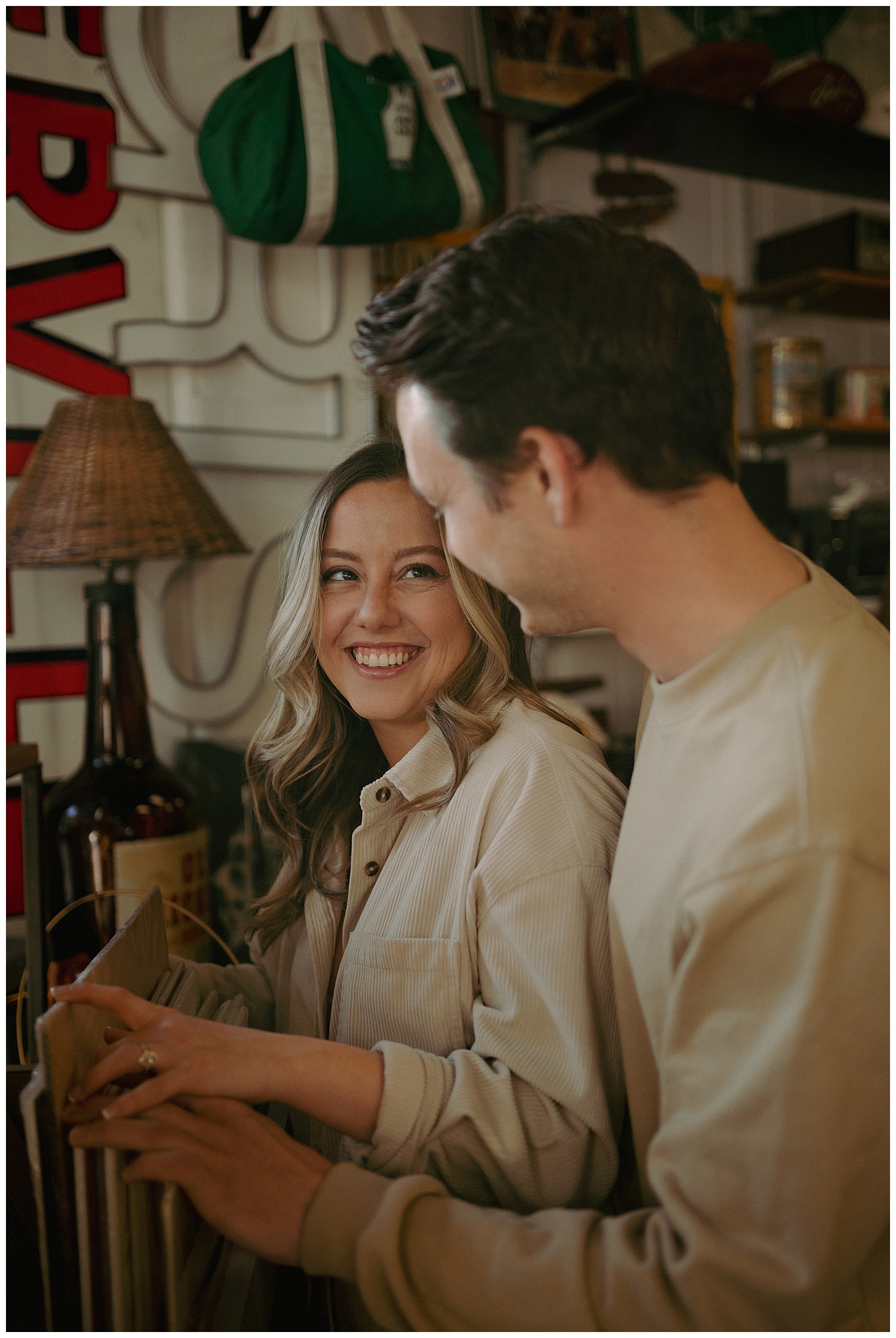Looking through records during their antique store engagement session