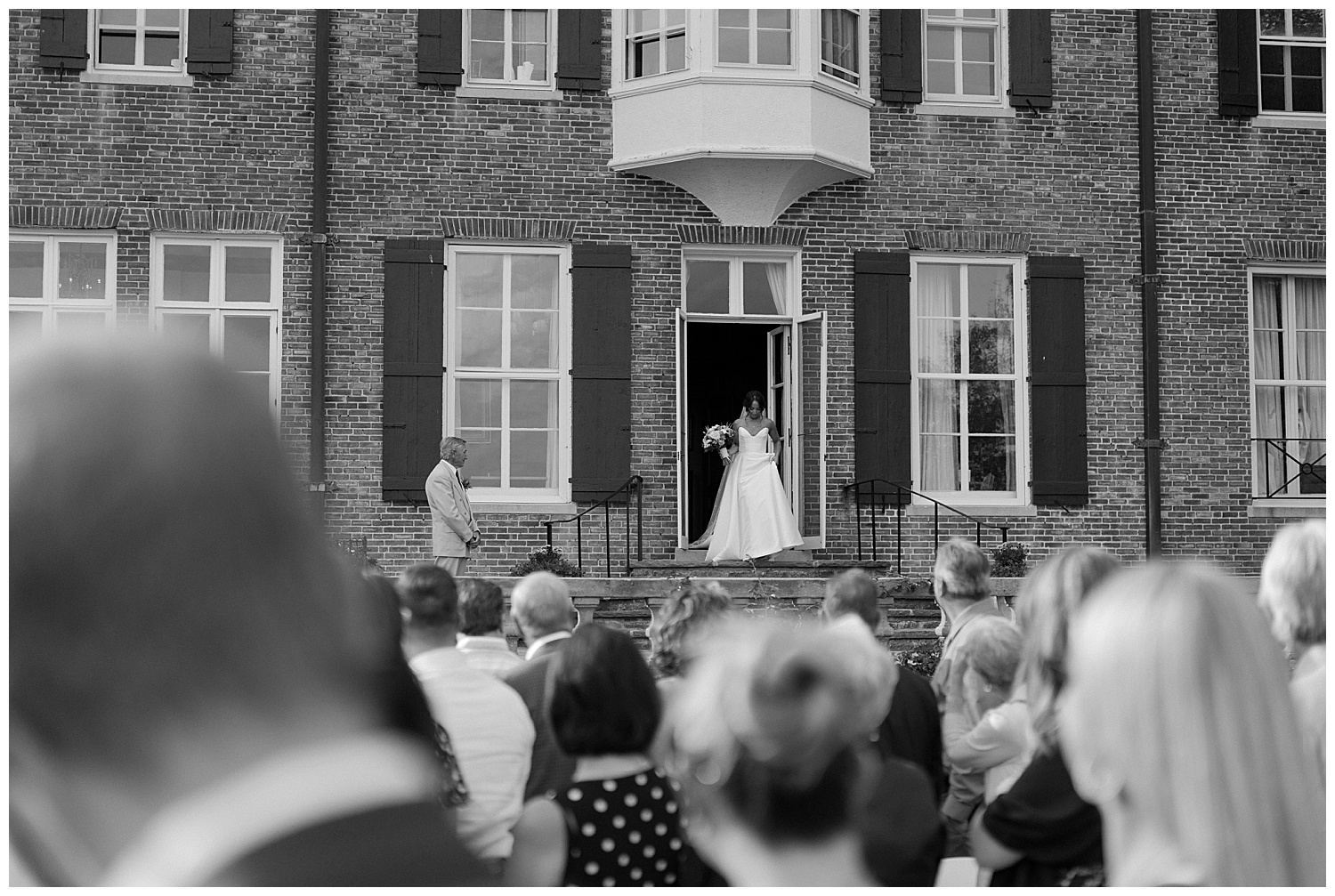 Bride preparing to walk down isle in black and white photo